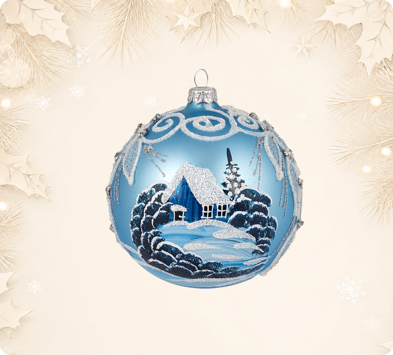 Light blue glass ball ornament painted with a snowy cottage