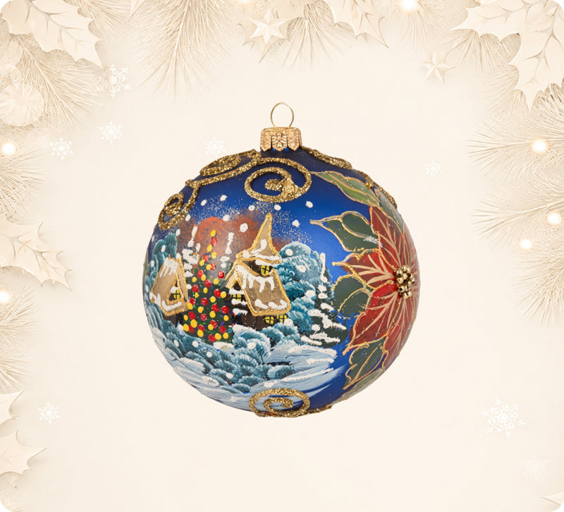 Blue glass ball ornament painted with a winter village and a poinsettia
