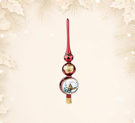 Red and gold glass tree topper painted with a cottage